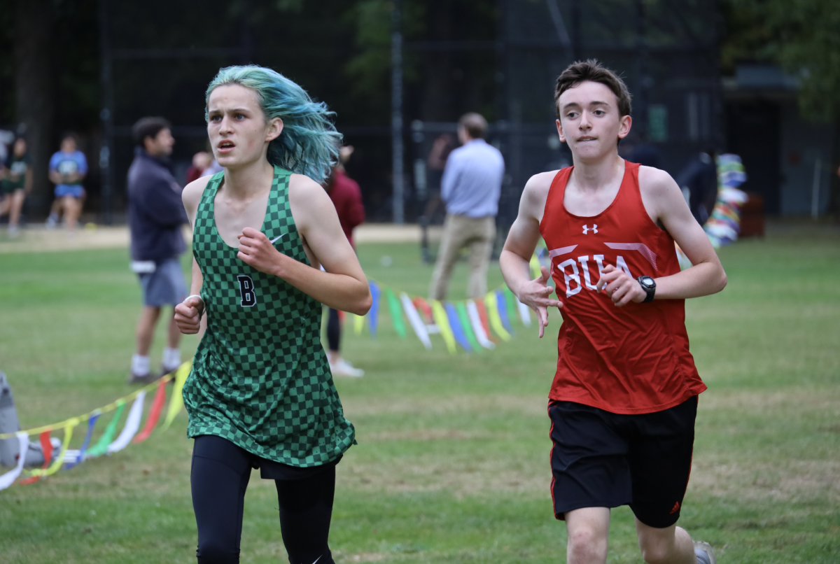 Isaac Morris '26 maintains a slight leave over a Boston University Academy runner as he heads toward the finish. 